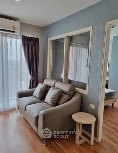 Cozy living room with modern sofa and large window in stylish apartment