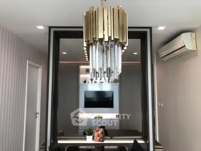Modern living room with elegant chandelier and wall-mounted TV