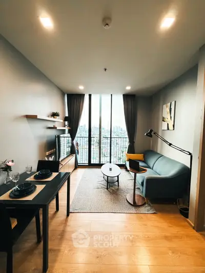 Modern living room with city view, stylish decor, and cozy seating area in a high-rise apartment.