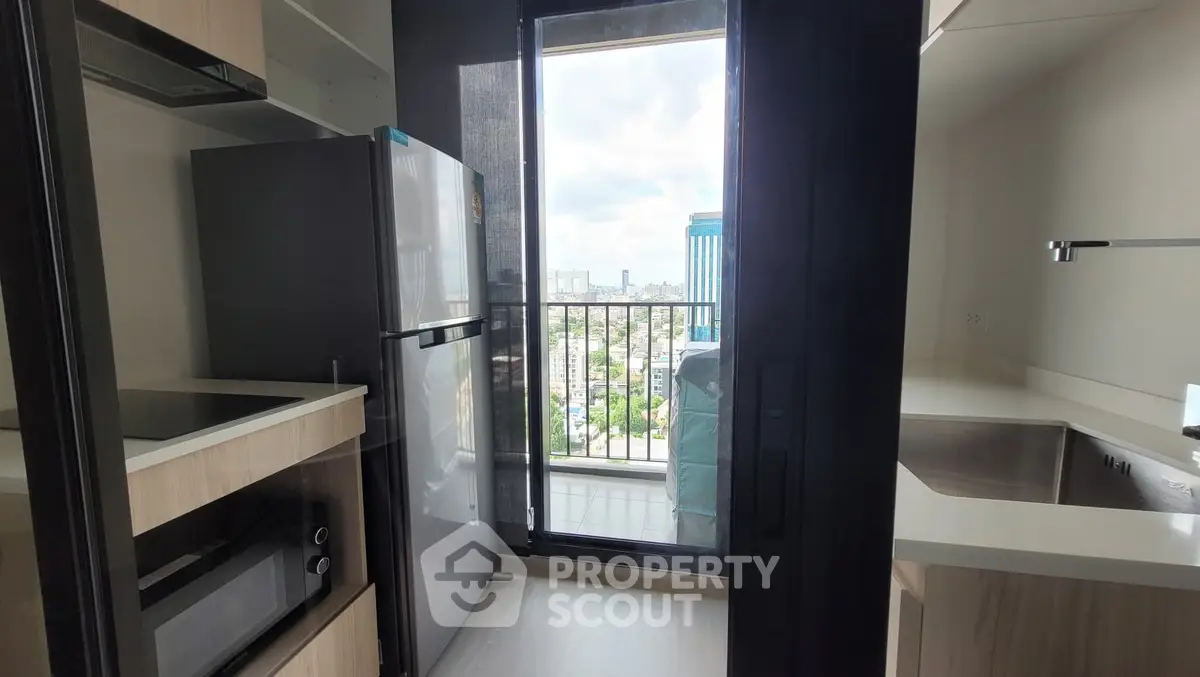 Modern kitchen with sleek appliances and balcony view