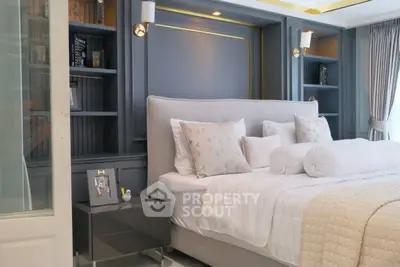 Luxurious bedroom with elegant decor and plush bedding in modern apartment.
