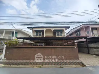 Charming two-story house with spacious front yard and classic architectural design.