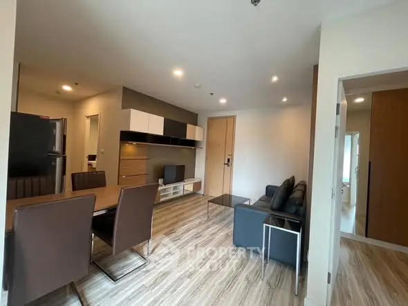 Modern living room with dining area and sleek wooden flooring