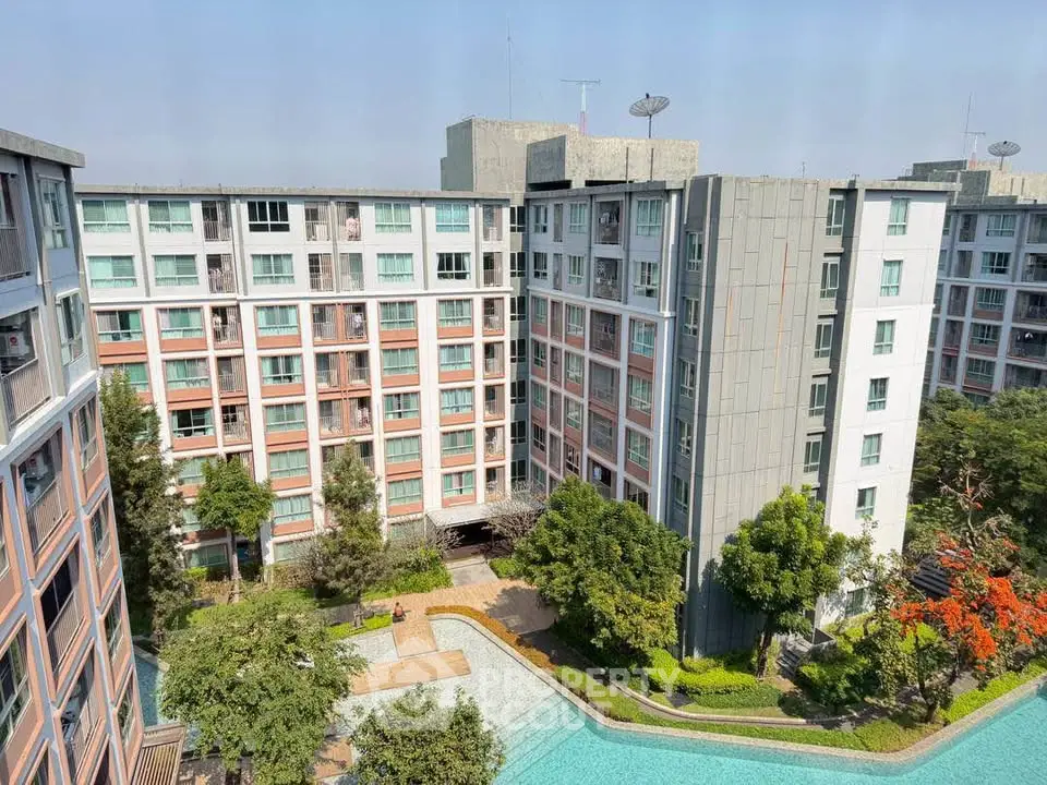 Modern apartment complex with lush garden and pool view