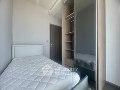 Cozy bedroom with modern wardrobe and comfortable bed in a bright apartment.