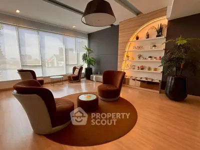 Stylish modern living room with elegant furniture and large windows offering city views.