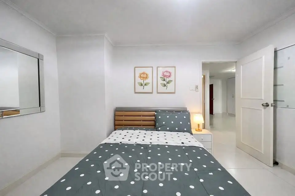 Cozy bedroom with modern decor and stylish bedding in a bright apartment.