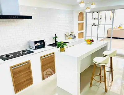 Modern kitchen with island, gas stove, and stylish decor