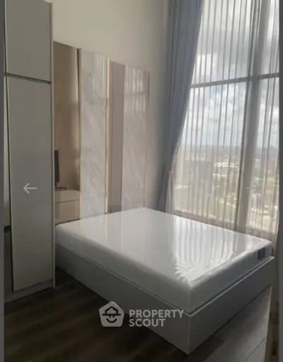 Modern bedroom with floor-to-ceiling windows and sleek minimalist design