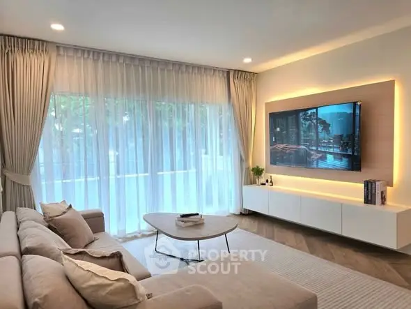 Elegant living room with modern decor and large window view