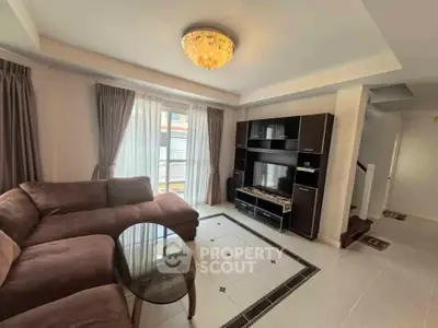 Spacious living room with elegant chandelier and modern entertainment unit