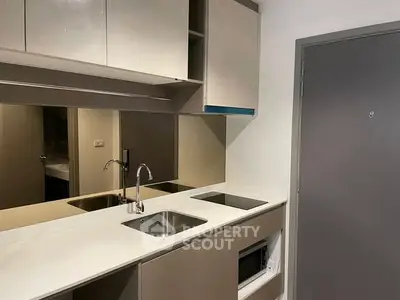 Modern compact kitchen with sleek cabinetry and built-in appliances