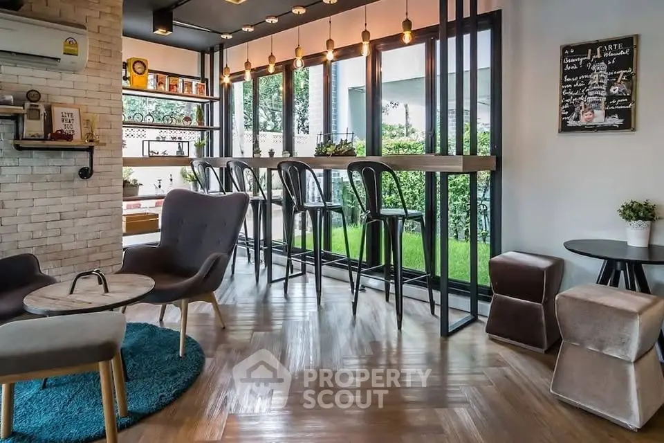Stylish modern living room with bar seating and garden view, perfect for relaxation and entertaining.