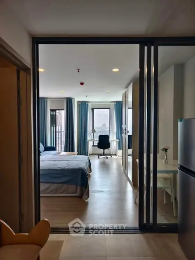 Modern studio apartment with bedroom, study area, and balcony view