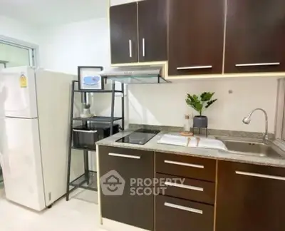 Modern kitchen with sleek cabinets and stainless steel appliances in a stylish apartment.