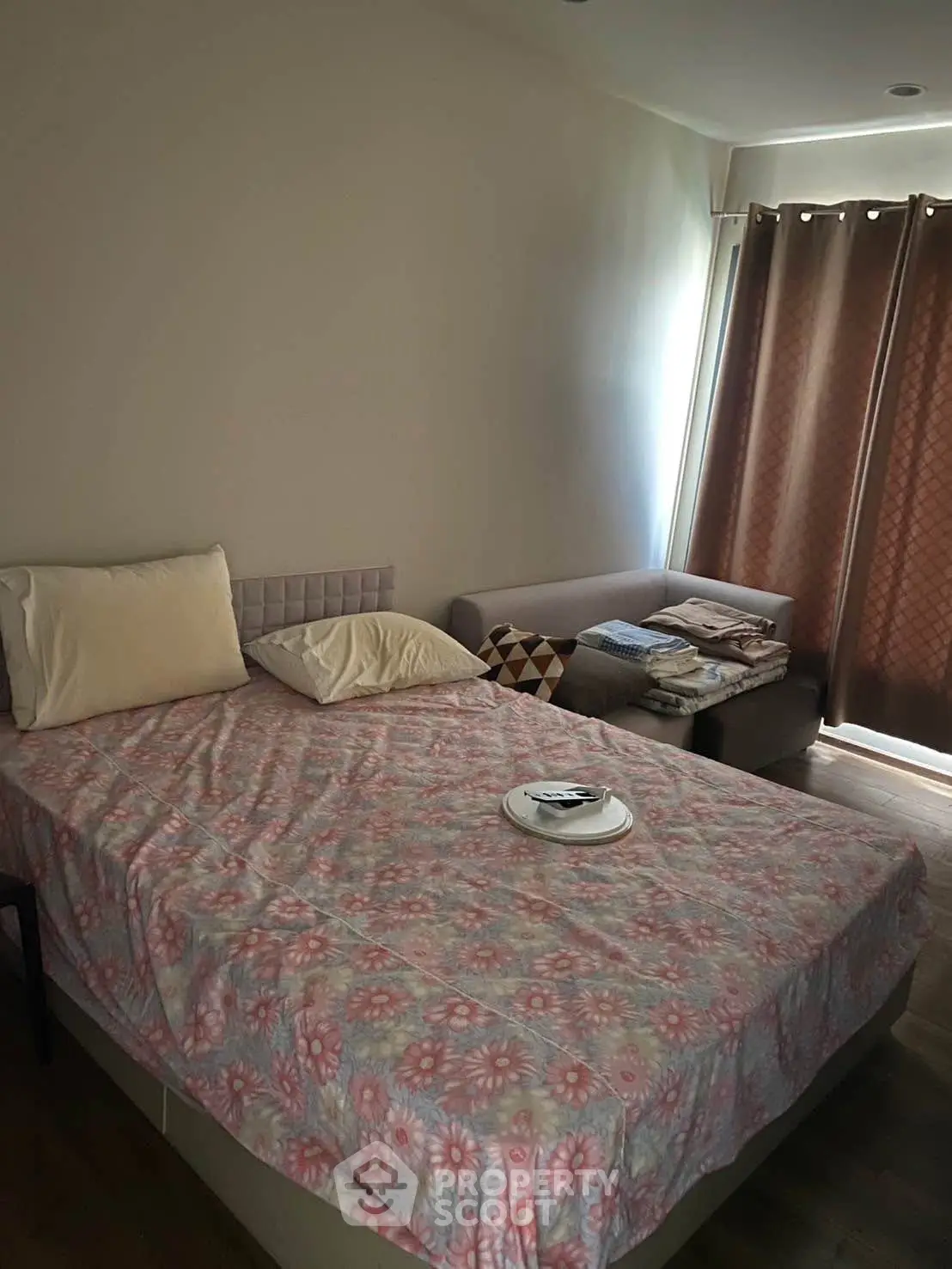 Cozy bedroom with natural light and stylish decor, perfect for relaxation and comfort.