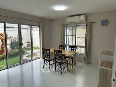 Spacious dining area with garden view and modern furnishings