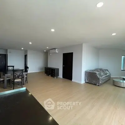 Spacious modern living room with dining area and natural light