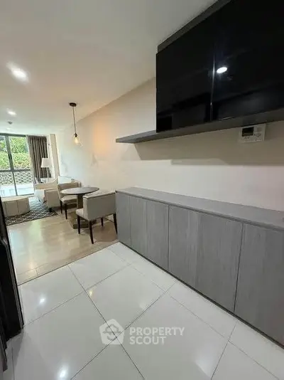 Modern living room with sleek furniture and natural light, perfect for stylish urban living.