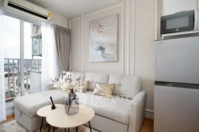 Modern living room with cozy sofa, stylish decor, and balcony view in a high-rise apartment.