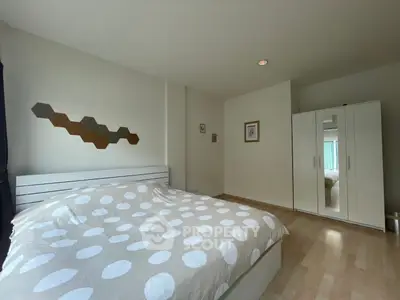 Spacious bedroom with modern decor and ample natural light