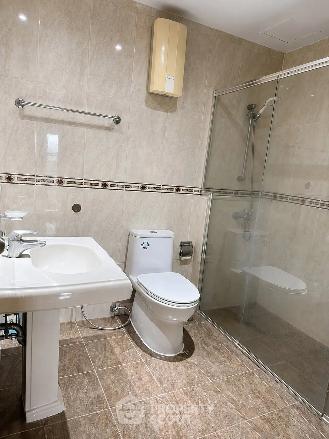 Modern bathroom with glass shower and elegant fixtures in a stylish real estate property.