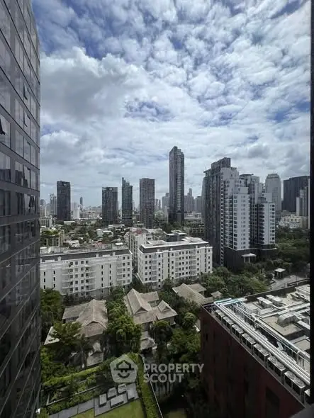 Stunning cityscape view from high-rise building showcasing urban skyline and lush greenery.