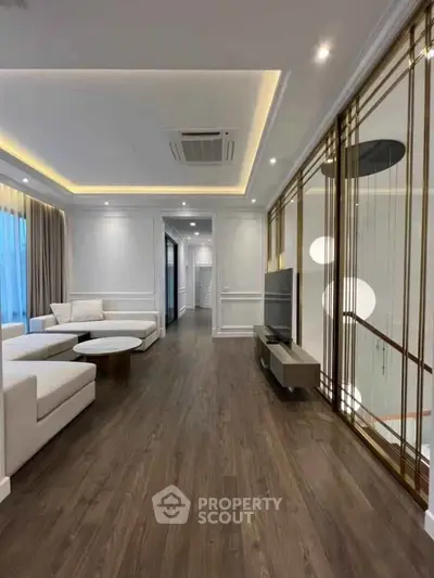 Luxurious modern living room with elegant decor and spacious layout, featuring stylish furniture and ambient lighting.