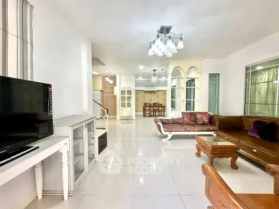 Spacious living room with elegant furniture and modern lighting in a stylish home.
