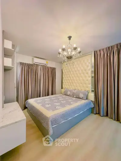 Luxurious bedroom with elegant chandelier and plush decor