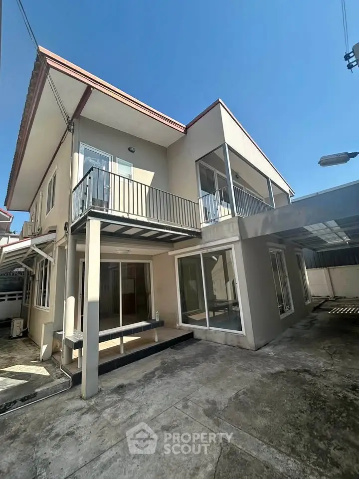 Spacious two-story house with modern design and large windows, perfect for family living.