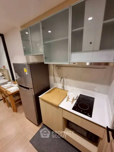 Modern compact kitchen with sleek appliances and stylish cabinetry