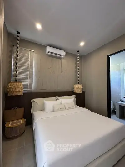 Modern bedroom with stylish decor and ensuite bathroom in luxury property.