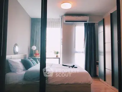Cozy bedroom with modern decor and ample natural light, featuring a comfortable bed and stylish furnishings.