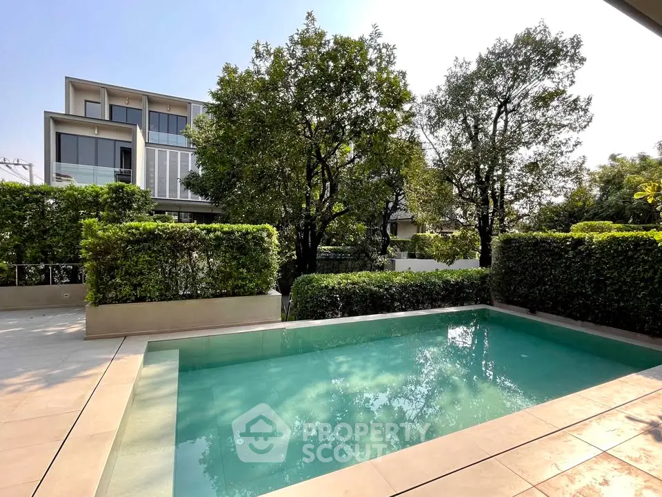 Luxurious private pool with lush greenery and modern architecture