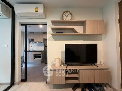 Modern living room with sleek wooden furniture and open kitchen layout