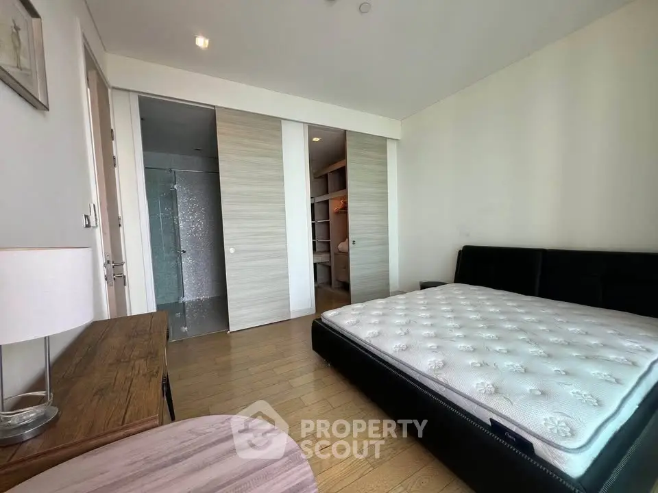 Spacious bedroom with modern design and wooden flooring