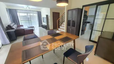 Spacious modern living and dining area with elegant furniture and natural light.