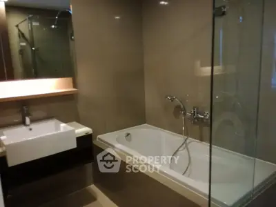 Modern bathroom with bathtub and glass shower enclosure