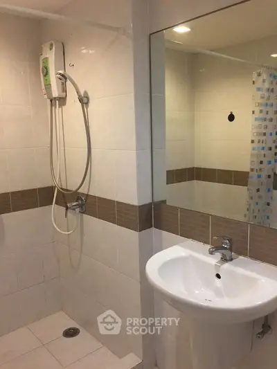 Modern bathroom with shower and sink in a tiled setting