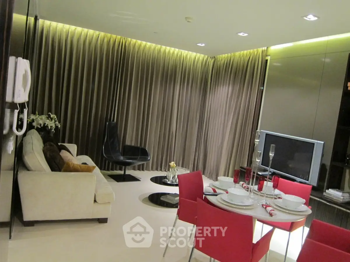 Modern living room with elegant decor and dining area, featuring stylish furniture and ambient lighting.