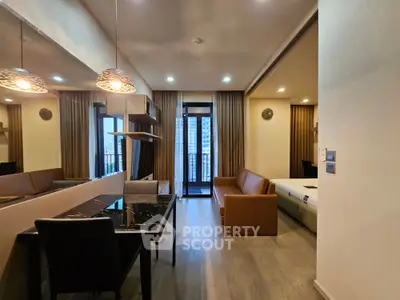 Modern apartment interior with open layout, stylish furniture, and city view balcony.