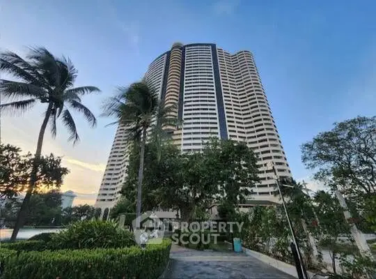 Stunning high-rise building with lush greenery and palm trees, perfect for luxurious urban living.