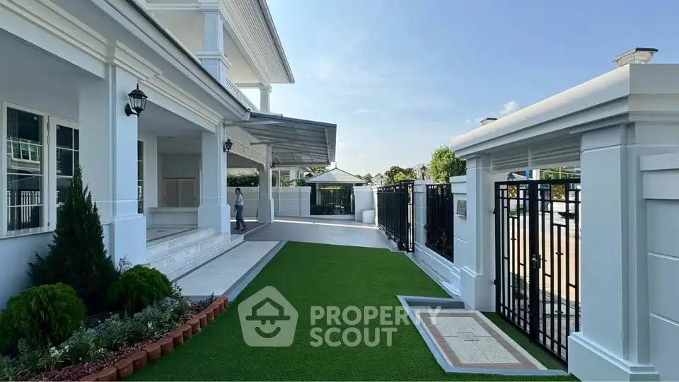 Luxurious modern home with spacious garden and elegant entrance