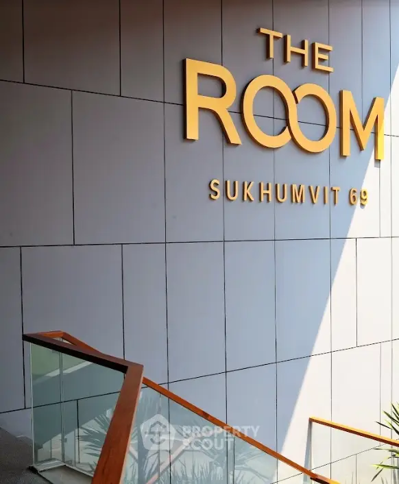 Modern building entrance with sleek design and stylish signage at Sukhumvit 69.