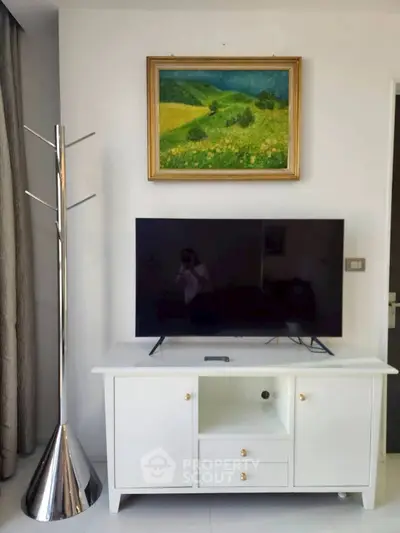Modern living room with sleek TV stand and vibrant landscape painting