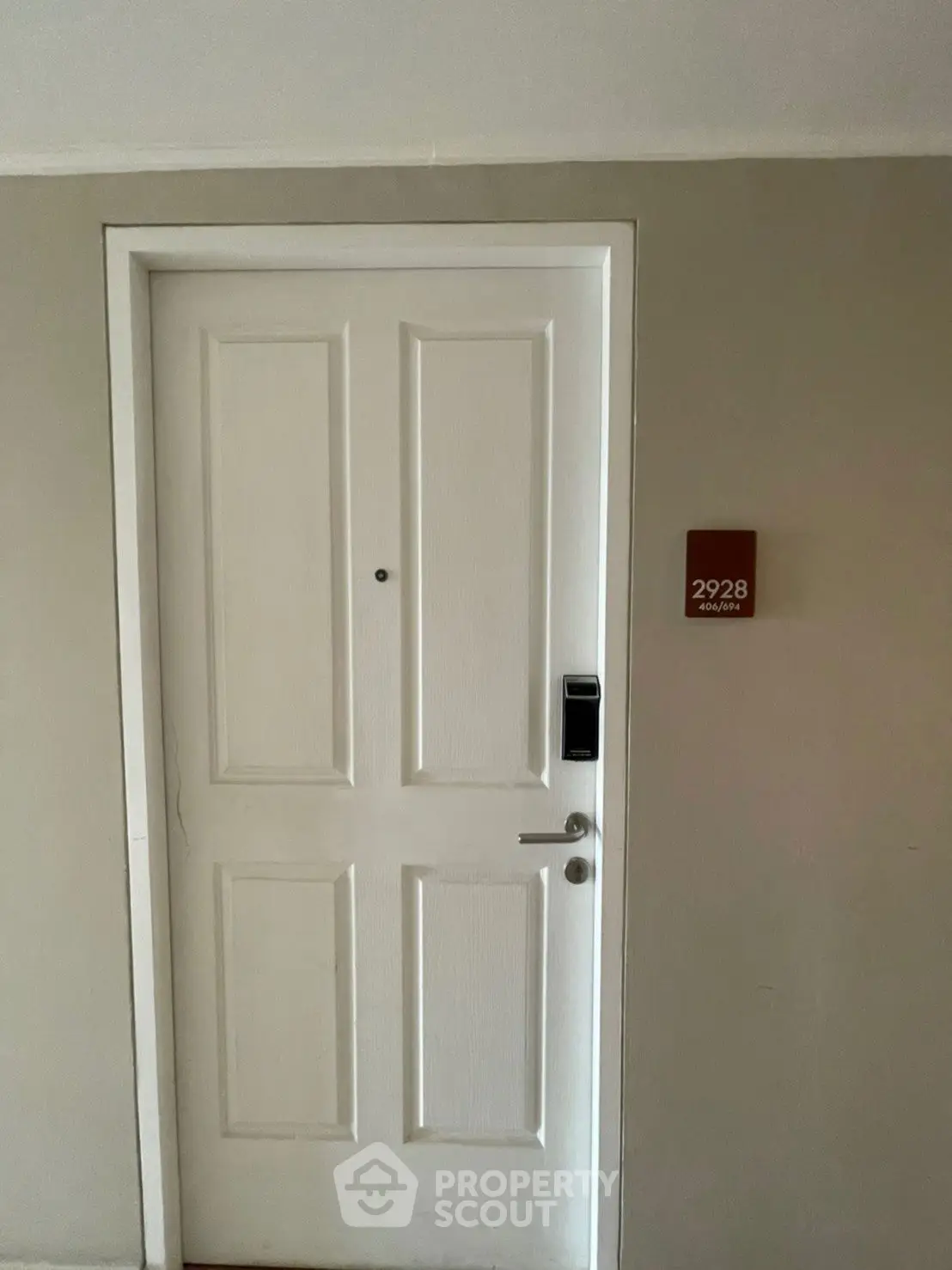 Modern apartment entrance with secure door and electronic lock system.