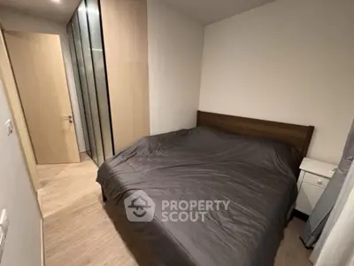 Cozy bedroom with modern wardrobe and wooden flooring