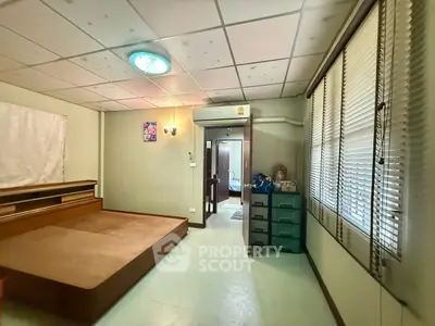 Spacious bedroom with platform bed and ample natural light