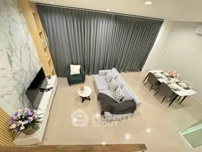 Modern living room with elegant decor and dining area, featuring a cozy sofa and stylish curtains.